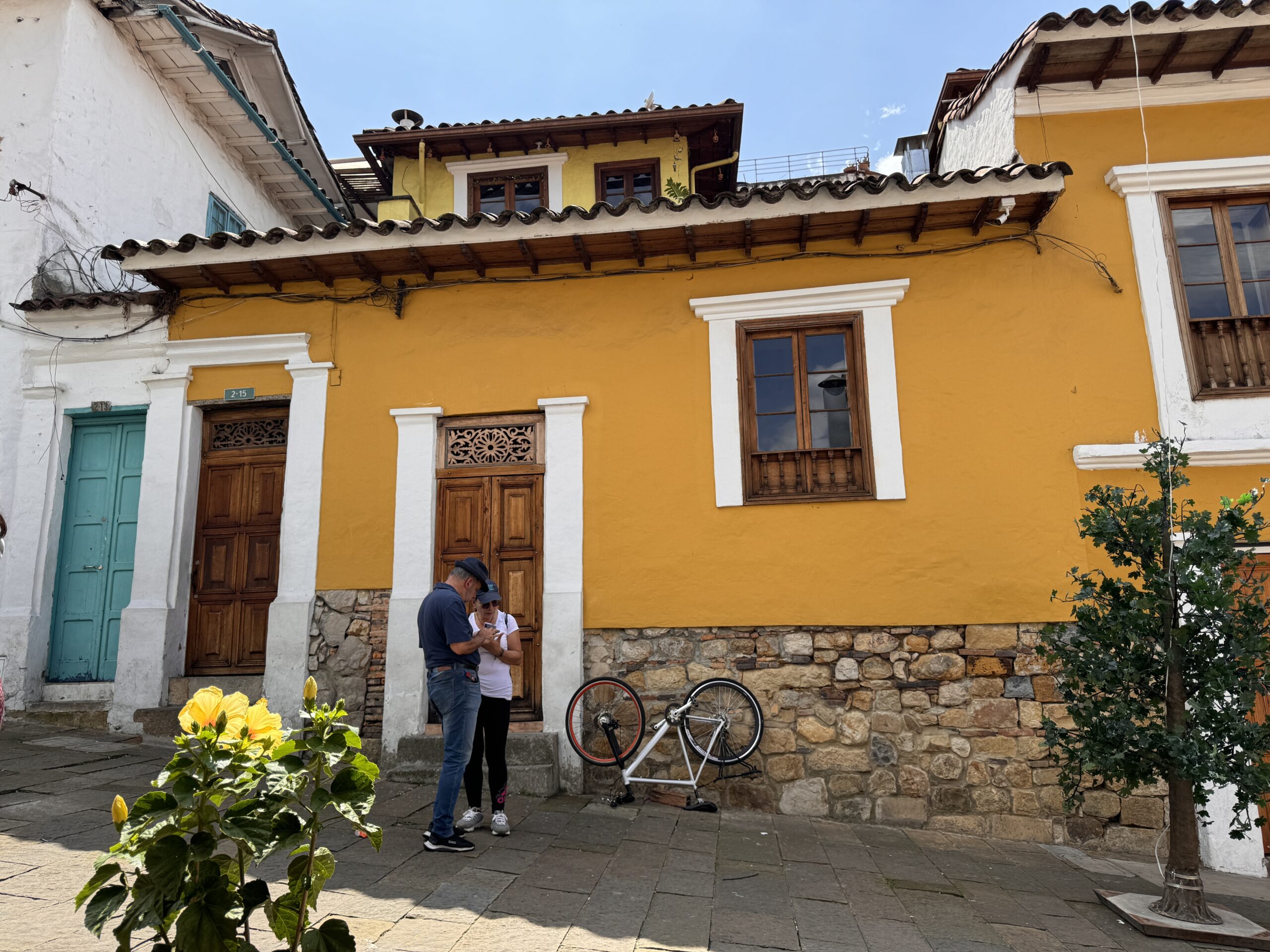 A charming yellow colonial house in Bogotá’s historic district, highlighting the rich culture and architecture found while travelling in Colombia.